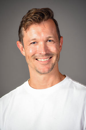 en person som smiler til kameraet